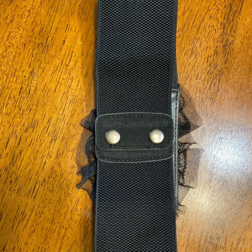 black belt with lace and sequins. Stretchy Size S/M. Snap closure.